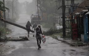 People at the Chandabali and Dhamra area of Bhadrak district, 160km from the eastern Indian state Odisha's capital city as Cyclone Amphan crosses the Bay of Bengal's eastern coast.