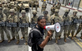 A protester speaks in front of the California National Guard during a demonstration over the death of George Floyd while in Minneapolis Police custody, in Los Angeles, California, June 2, 2020.