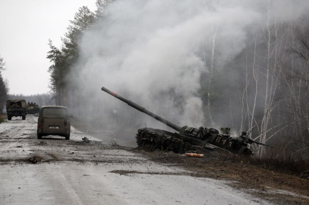 Smoke rises from a Russian tank destroyed by Ukrainian forces in Lugansk region on February 26, 2022.