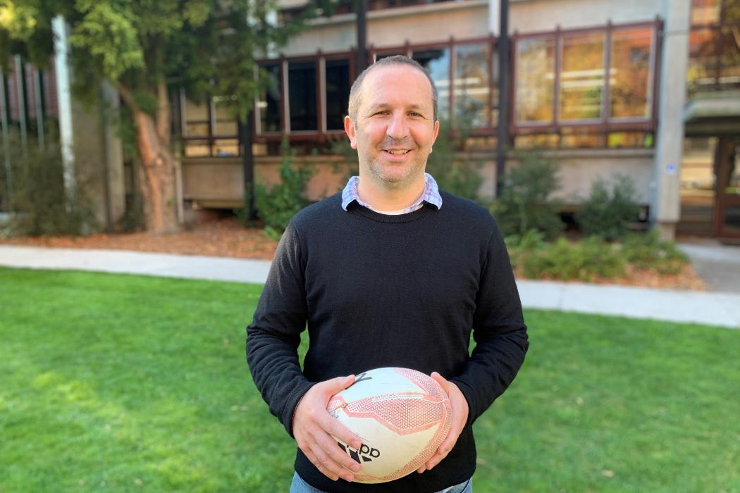 Brad Miles, University of Canterbury stands holding a rugby ball