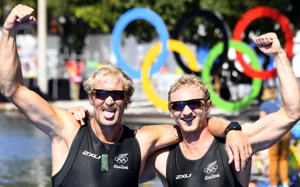 New Zealand's Hamish Bond (R) and New Zealand's Eric Murray celebrate at the end of the Men's Pair final rowing competition at the Lagoa stadium during the Rio 2016 Olympic Games in Rio de Janeiro on August 9, 2016.