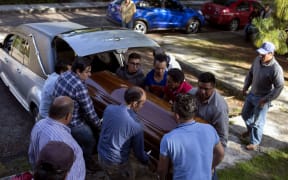 Relatives of Ocampo mayoral candidate Fernando Angeles carry the coffin during his funeral.