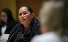 ACT MP Nicole McKee watching a public submitter in committee