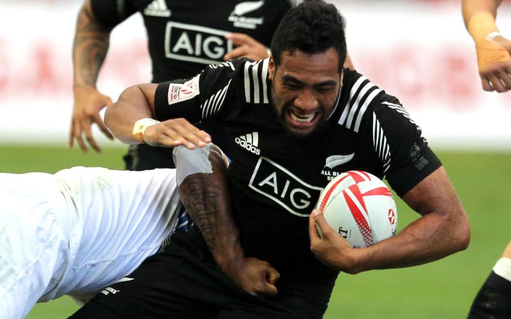 The All Black Sevens' Siona Molia is tackled by a French man.