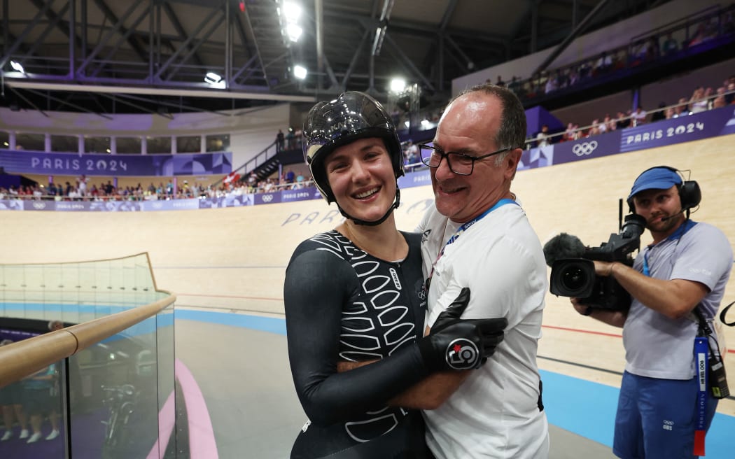 New Zealand's Ellesse Andrews (L) celebrates after winning the women's track cycling keirin final for gold of the Paris 2024 Olympic Games at the Saint-Quentin-en-Yvelines National Velodrome in Montigny-le-Bretonneux, south-west of Paris, on 8 August, 2024.