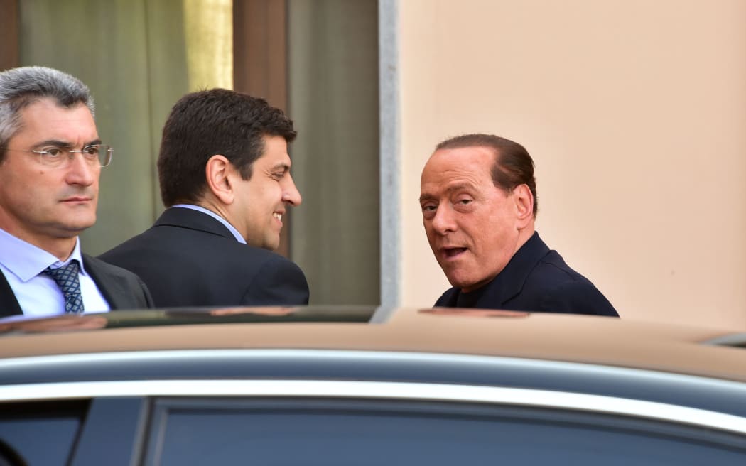 Berlusconi (L) arrives at the hospice.