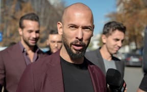 Andrew Tate talks to reporters outside the Court of Appeal on October 15, 2024 in Bucharest, Romania.