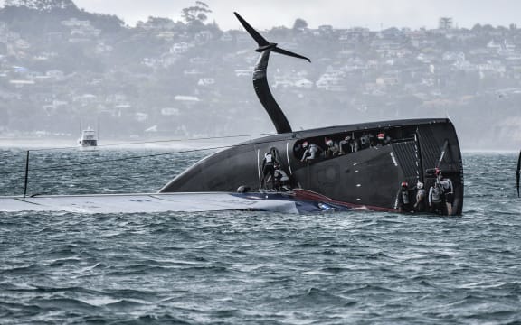 American Magic capsized just before the final leg in race three of the Prada Cup.