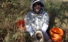 Bob Brown with a wasp nest he has dug up.