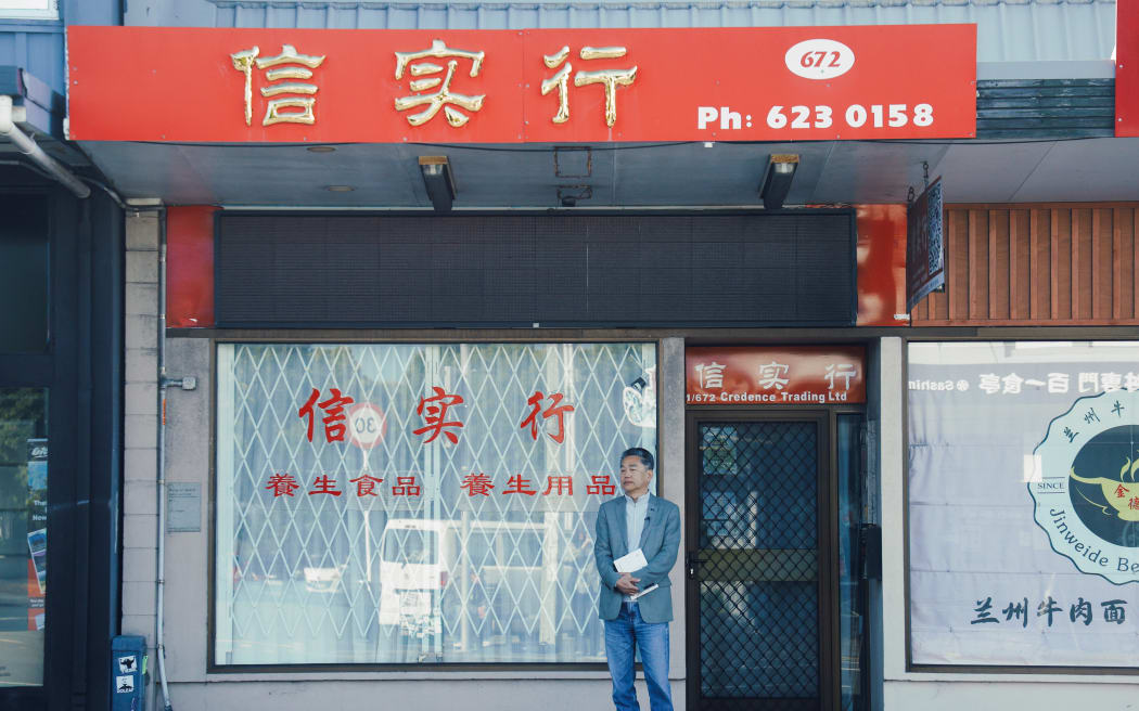 Hua Fang standing at 672 Dominion Road, the former site of his bookstore.