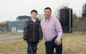 Michael Hickey and son Oliver in front of Hoosick Falls new water filtration plant.