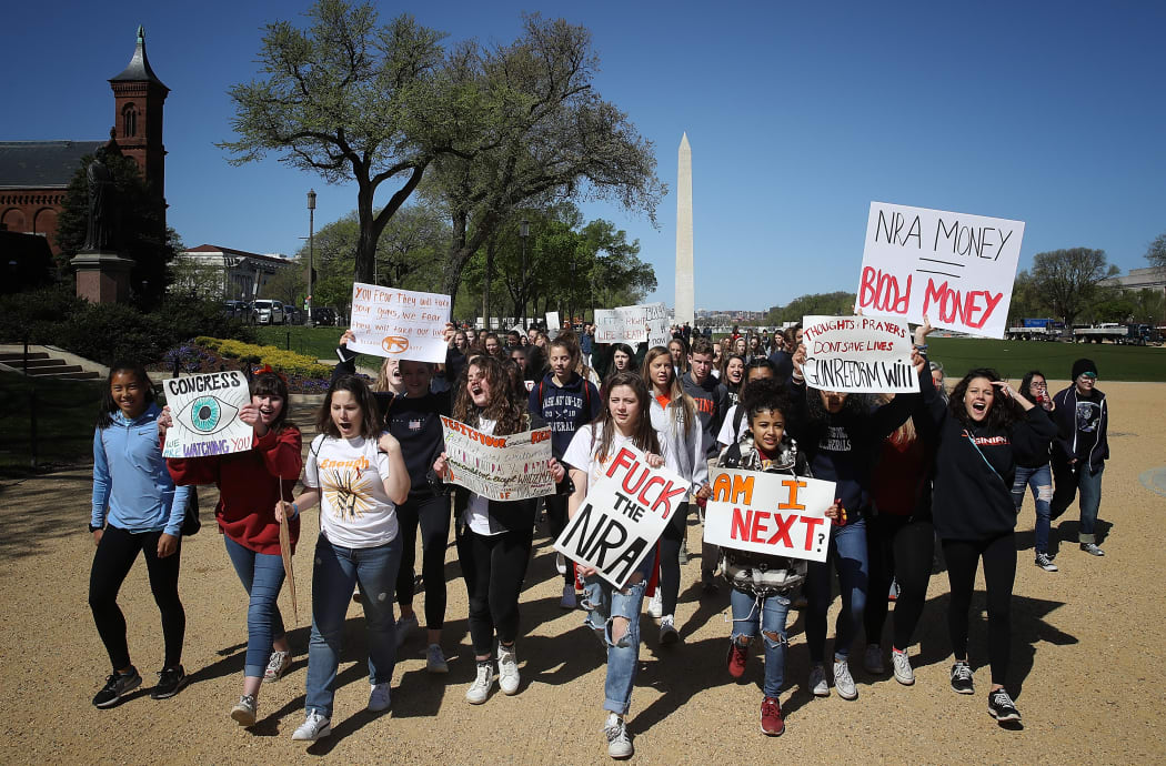 Students from Washington-Lee High School in Arlington, Virginia join the National School Walkout April 20, 2018 in while marching to the U.S. Capitol in Washington, DC.