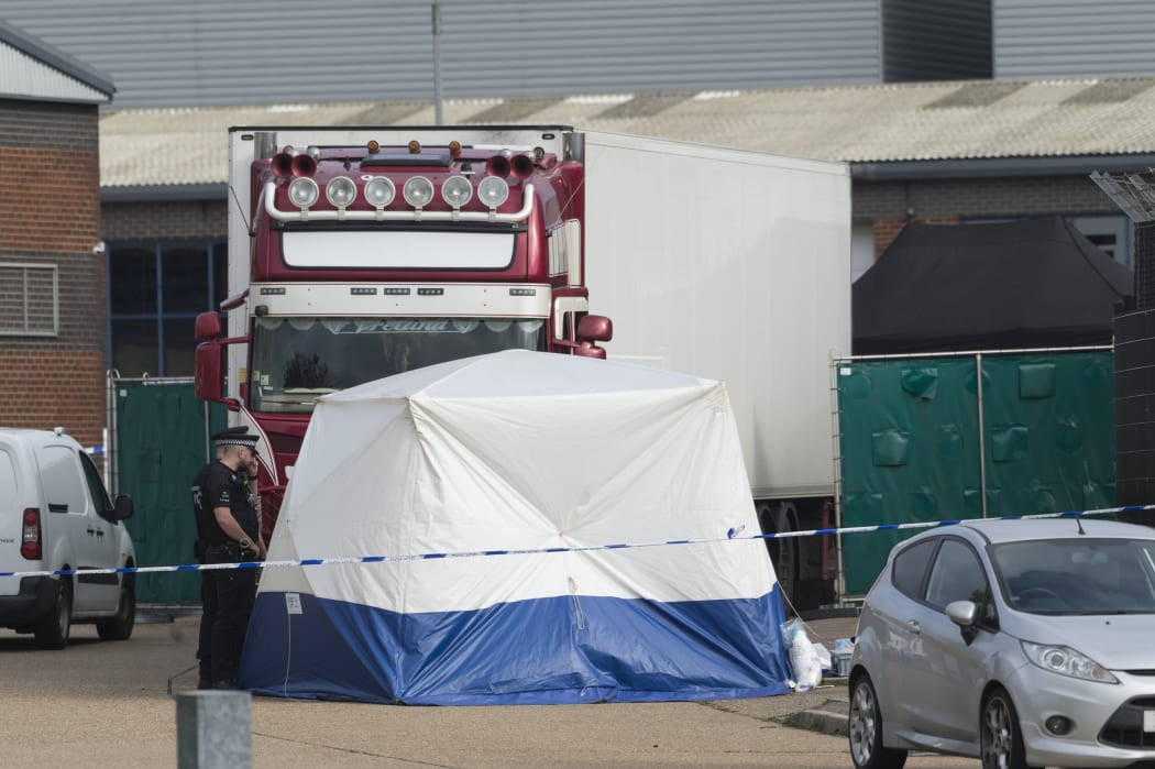 Police officers work at the scene where 39 bodies were found in a shipping container at Waterglade Industrial Park in Essex, Britain, on Oct. 23, 2019.