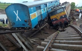 The trains were crossing a partially flooded bridge when they derailed