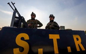 Members of the Iraqi security forces stand guard atop an armoured vehicle in Baghdad on January 4, 2024. A US strike in Baghdad on January 4 killed a military commander of the PMF, an ex-paramilitary faction of the grouping said, with an Iraqi security official reporting two deaths in a drone attack. Harakat al-Nujaba, one of the PMF's factions, said in a statement that "the deputy commander of operations for Baghdad, Mushtaq Talib al-Saidi", had been "martyred in a US strike".