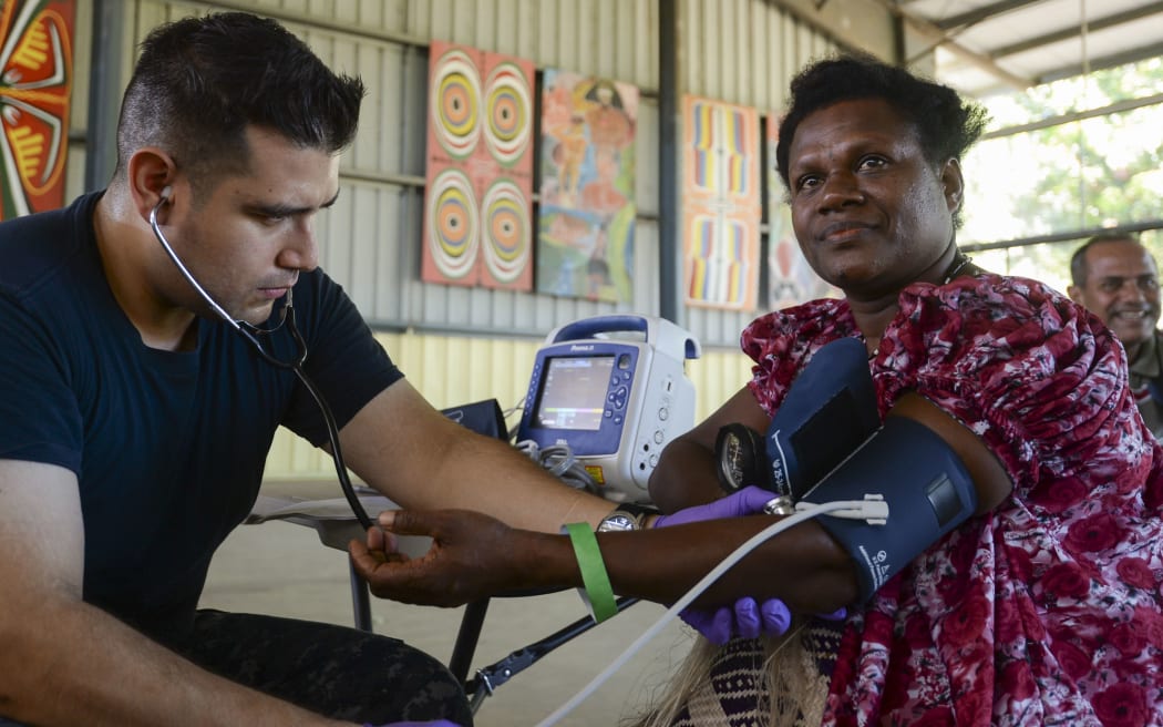 Papua New Guinea (July 7, 2015) Hospitalman Jaime Cavalleroserna, from San Francisco, takes patient vitals during a community health engagement. Medical personnel from the hospital ship USNS Mercy (T-AH 19) arrived in Kokopo  during Pacific Partnership 2015.