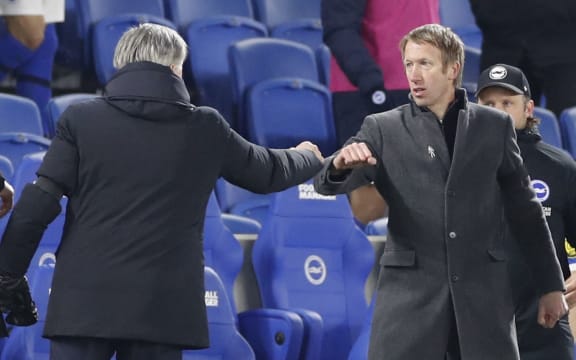 Everton's Italian head coach Carlo Ancelotti salutes Brighton's English manager Graham Potter (R) after the English Premier League football match between Brighton and Hove Albion and Everton at the American Express Community Stadium in Brighton, southern England on April 12, 2021.