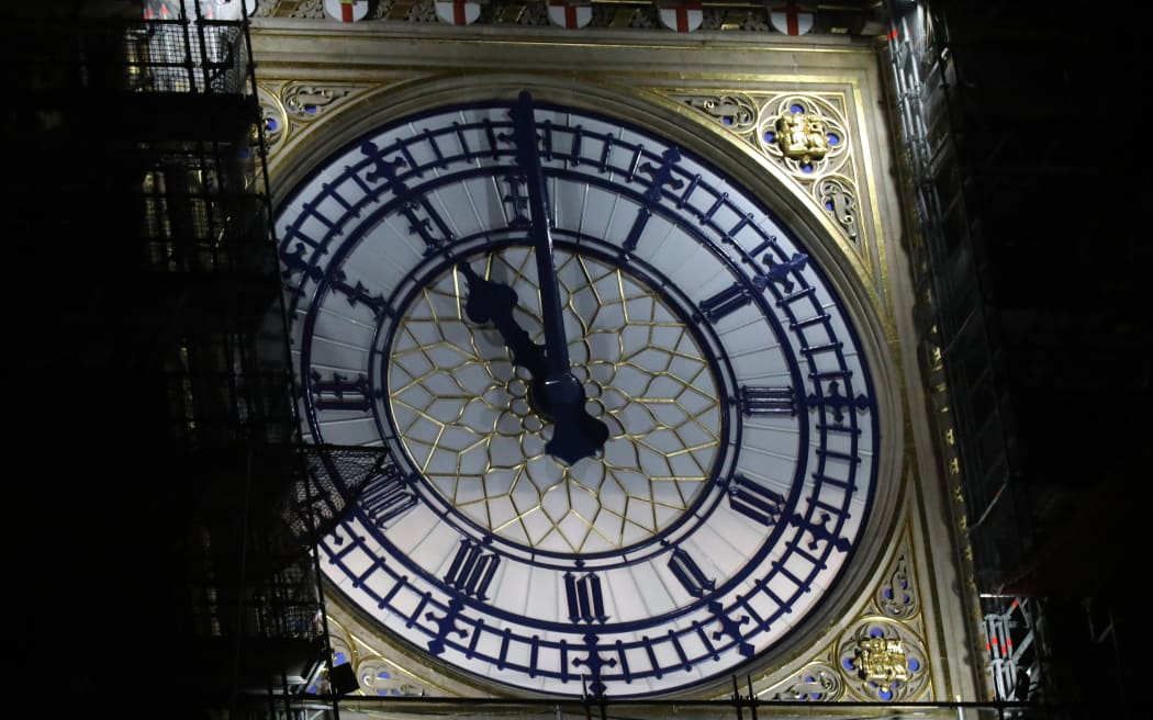 The clock face of Elizabeth Tower, known more commonly after the name of bell inside, Big Ben, shows the hands at eleven o'clock at night, at the Houses of Parliament in central London on January 31, 2020.