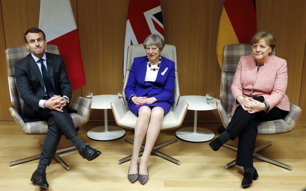 British Prime Minister Theresa May (C), German Chancellor Angela Merkel (R) and French President Emmanuel Macron.