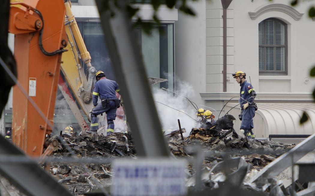 Relief workers sift through the wreckage of the CTV building following the February 2011 earthquake in Christchurch.