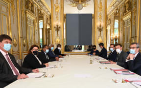 New Caledonian leaders (left) met with the French President Emmanuel Macron and other ministers and officials in Paris on Tuesday.
