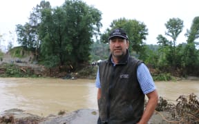 Rissington Station farmer, Jeremy Absolom, standing at the site of the now destroyed Rissington Bridge, which was taken out by Cyclone Gabrielle.