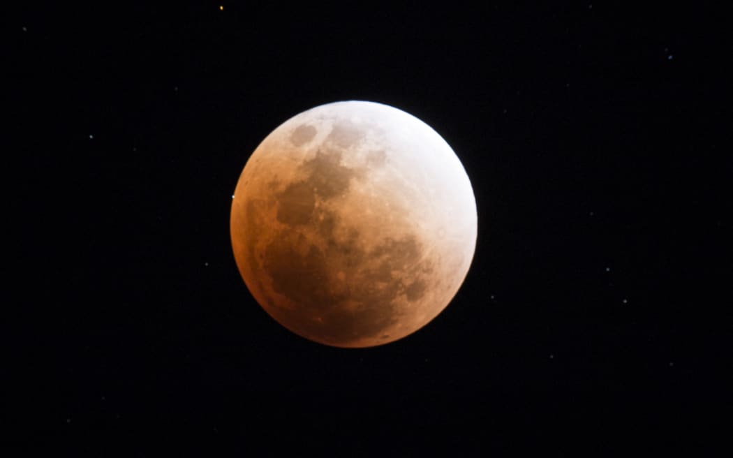 The moon is seen during a lunar eclipse, referred to as the "super blue blood moon", in Kumal, some 105 kms away from Mandalay City on January 31, 2018. Skywatchers were hoping for a rare lunar eclipse that combines three unusual events -- a blue moon, a super moon and a total eclipse -- which was to make for a large crimson moon viewable in many corners of the globe. (Photo by YE AUNG THU / AFP)