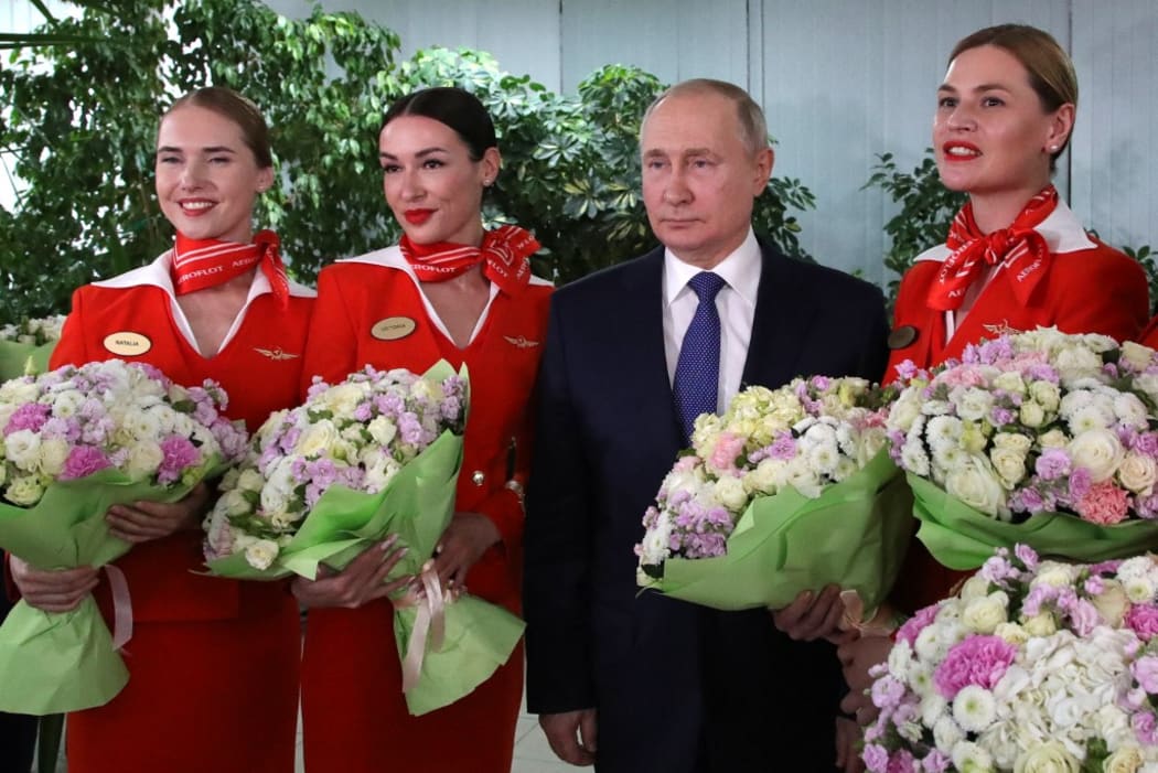 Russian President Vladimir Putin is photographed with representatives of the flight crew of Russian airlines during his visit to the Aeroflot aviation training complex, in Moscow region, Russia.