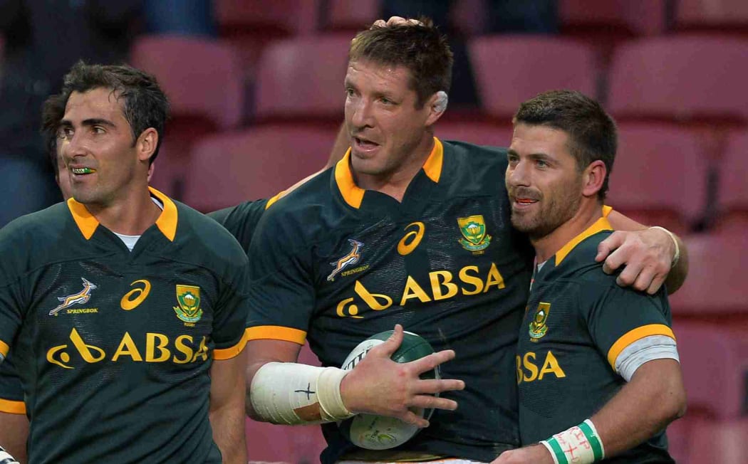 Bakkies Botha of South Africa celebrates his try with Willie le Roux of South Africa and Ruan Pienaar of South Africa.