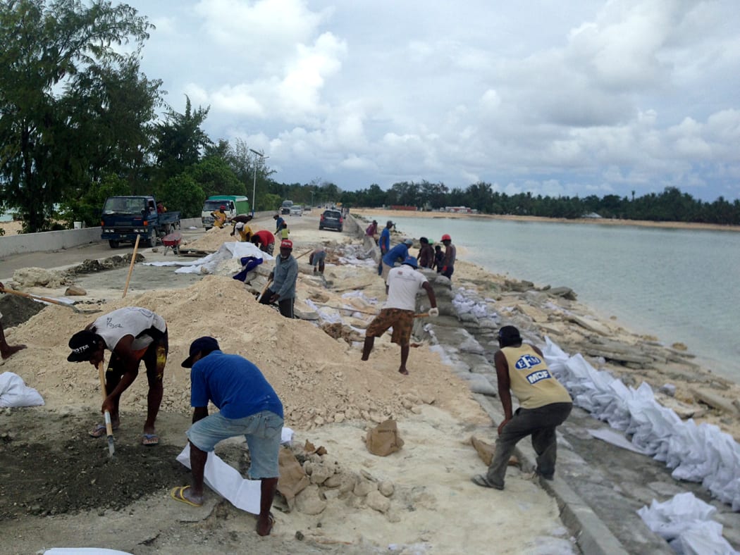 Sand bagging the beach to stop erosion in Tarawa, Kiribati.