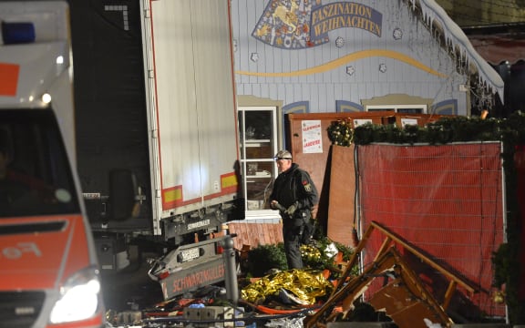 An officer inspects the truck after it crashed into a crowd near a Christmas market in Berlin.