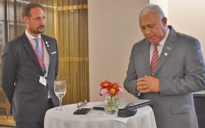 Crown Prince of Norway Haakon Magnus watching Frank Bainimarama launching the fund.