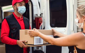 A courier driver delivers a package.