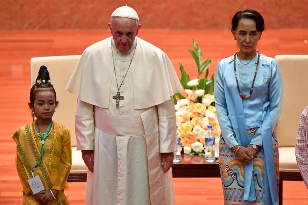 Pope Francis stands beside Myanmar's civilian leader Aung San Suu Kyi.