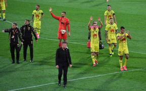 Phoenix head coach Ufuk Talay leads his team from the feild.