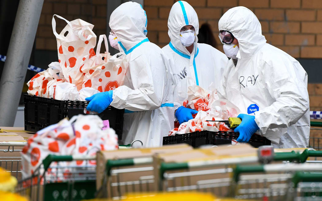 Members of the Melbourne Fire Brigade (MFB) prepare to take food parcels to residents in a locked down public housing estate in Melbourne on July 9, 2020 as the city re-enters a city wide lockdown after a fresh outbreak of the COVID-19 coronavirus.