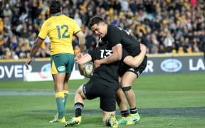 Jack Goodhue celebrates his try with Anton Lienert-Brown.