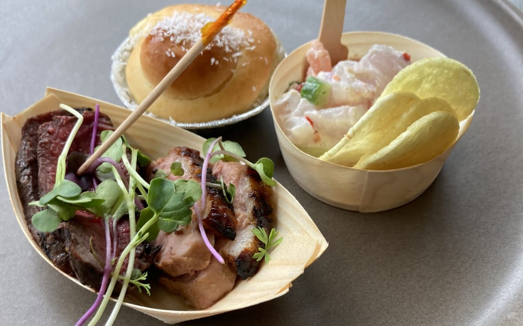 A plate showing bite sized portions of kokoda, venison, duck and coconut bun.