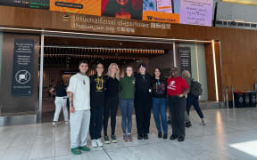 The six young New Zealanders and Save the Children New Zealand's youth engagement co-ordinator Vira Paky (right).