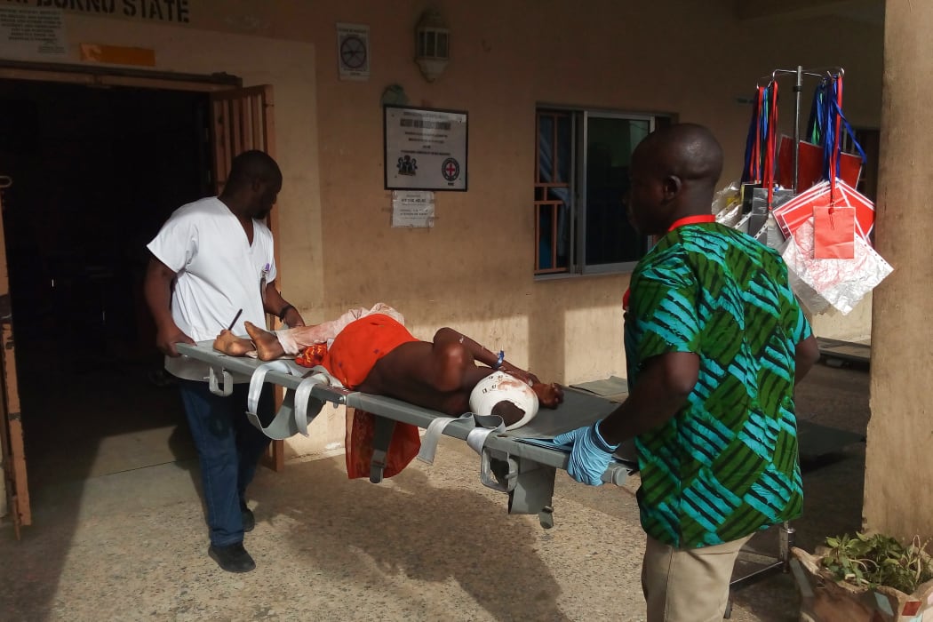 Paramedics stretcher a victim of a blast at the hospital in Maiduguri on June 17, 2018.
