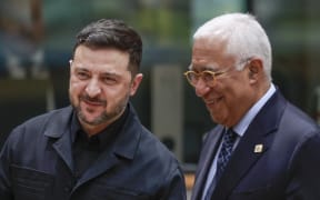 Ukrainian President Volodymyr Zelensky (L) speaks with European Council President Antonio Costa during a EU summit in Brussels on December 18, 2025. EU leaders kicked off a make-or-break summit on December 18, 2025 on using frozen Russian assets to fund Ukraine, with key player Belgium under pressure to drop its opposition. (Photo by Stephanie Lecocq / POOL / AFP)