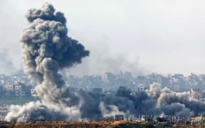 This picture taken from the Israeli side of the border with the Gaza Strip shows smoke plumes rising from explosions above destroyed buildings in the northern Gaza Strip on January 14, 2025, amid the ongoing war between Israel and Hamas.