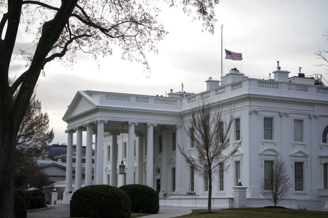 The American flag flies at half-staff at the White House on March 19, 2021 in Washington, DC. President Joe Biden ordered  U.S. flags on federal buildings to be lowered to half-staff to mark the shooting that killed eight people in Georgia.