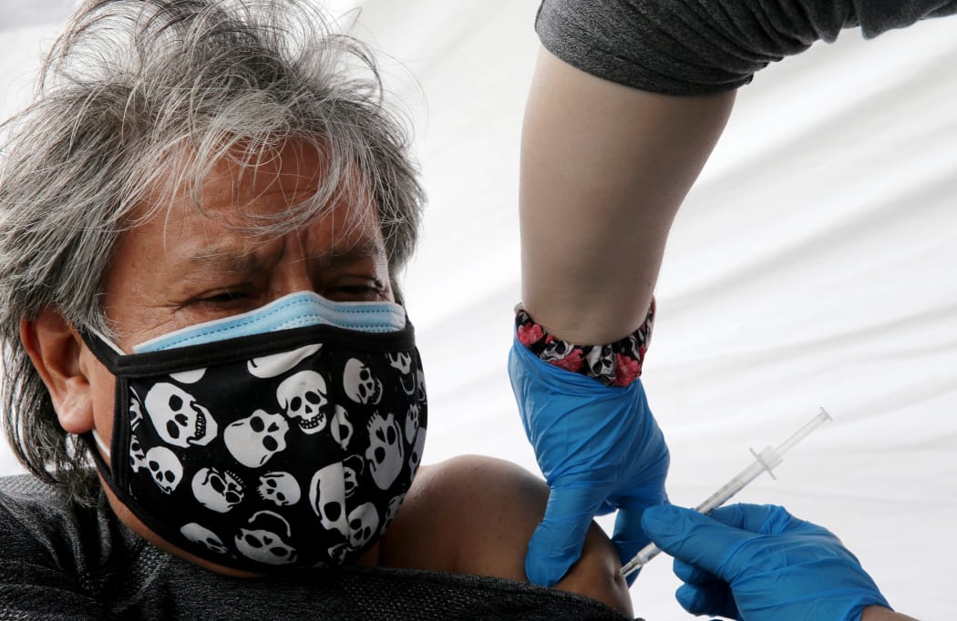LOS ANGELES, CALIFORNIA - MARCH 25: Gregorio Noriega, originally from Mexico, receives a one-shot dose of the Johnson & Johnson COVID-19 vaccine at a clinic targeting immigrant community members on March 25, 2021 in Los Angeles, California.