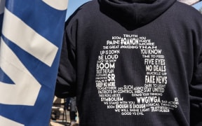 A person wearing a QAnon sweatshirt during a pro-Trump rally in New York City. The event, which was organized weeks ago, encouraged people to vote Republican and to pray for the health of President Trump who fell ill with Covid-19.