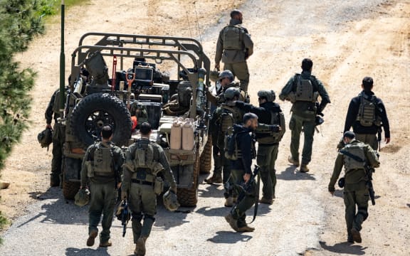 Israeli army soldiers gather on the border with Lebanon in the Upper Galilee, northern Israel on March 16, 2026. The Israeli military said on March 16 that it had begun what it described as "limited ground operations" against Hezbollah in southern Lebanon. Lebanon was drawn into the Middle East war on March 2 when the Tehran-backed Hezbollah attacked Israel in response to the killing of the Iranian supreme leader in US-Israeli strikes, with Israel launching air raids on the neighbouring country and troop incursions into border areas.