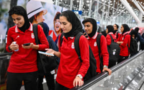 Members of Iran's women's football team arrive at the Kuala Lumpur International Airport after taking part in the AFC Women’s Asian Cup Australia 2026 tournament in Australia, in Sepang on March 11, 2026. At least five players from Iran's visiting women's football team claimed asylum in Australia on on March 10, seeking protection after they were branded "traitors" at home for refusing to sing the national anthem. (Photo by Mohd RASFAN / AFP)