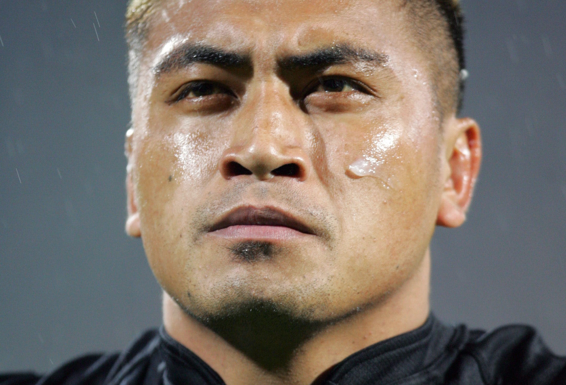 Jerry Collins listens to the national anthem during a match between the All Blacks and France in Lyon in 2006.