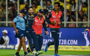 Gujarat Titans' Kane Williamson is helped by teammates back to Pavillion after he was injured during the Indian Premier League match between Gujarat Titans and Chennai Super Kings, 2023.