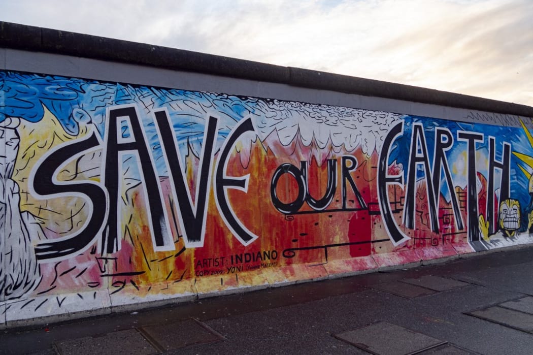 GERMANY. BERLIN. FRIEDRICHSHAIN-KREUZBERG, EAST SIDE GALLERY OPEN-AIR MUSEUM OF 1.3KM LONG WHICH INCLUDES THE MOST BEAUTIFUL PAINTINGS MADE ON THE OLD WALL BERLIN. SAVE OUR EARTH DE INDIANO (Photo by NORBERT SCANELLA / ONLY WORLD / Only France via AFP)